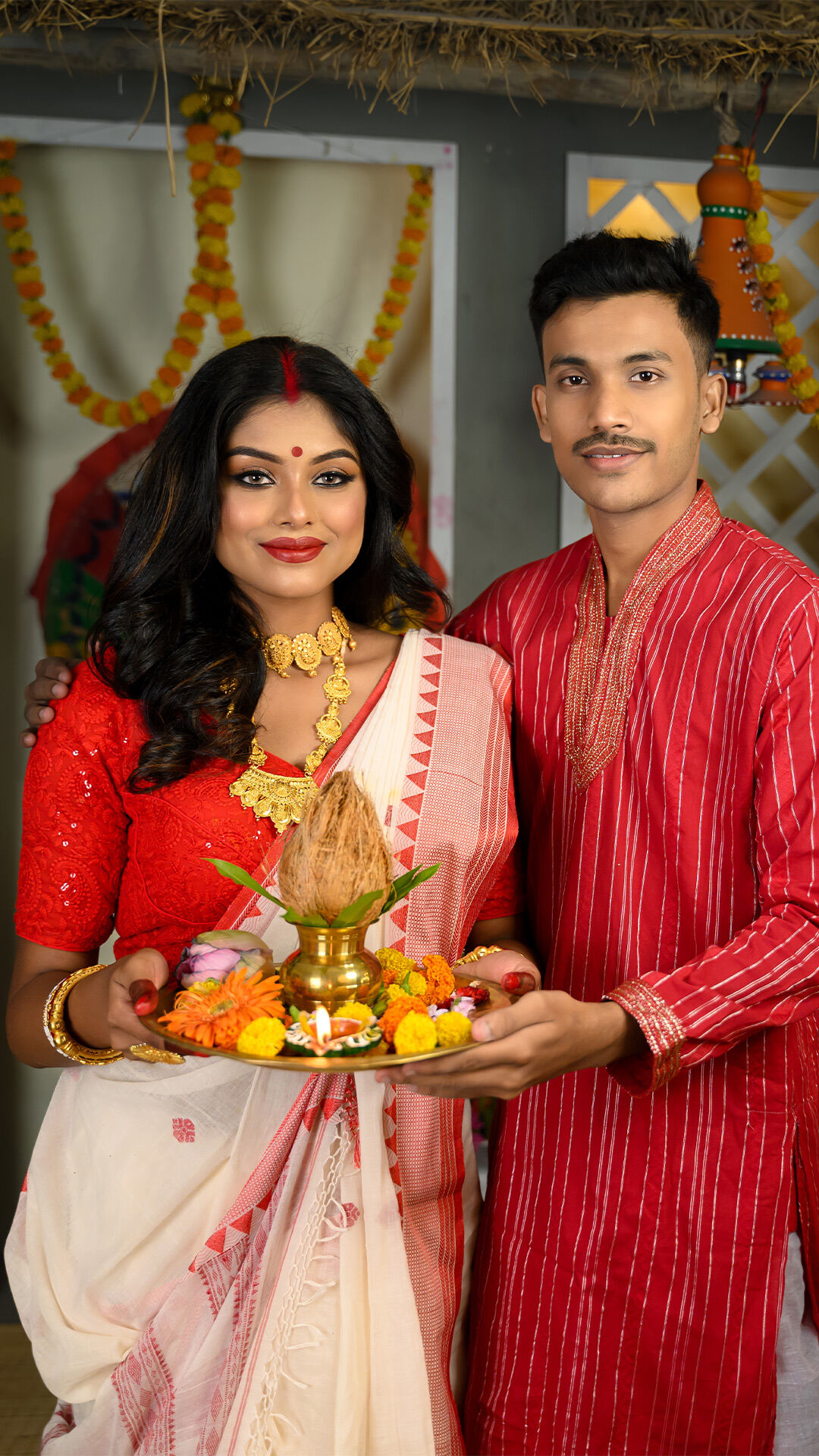 Traditional Indian couple celebrating Akshaya Tritiya with decorated puja thali