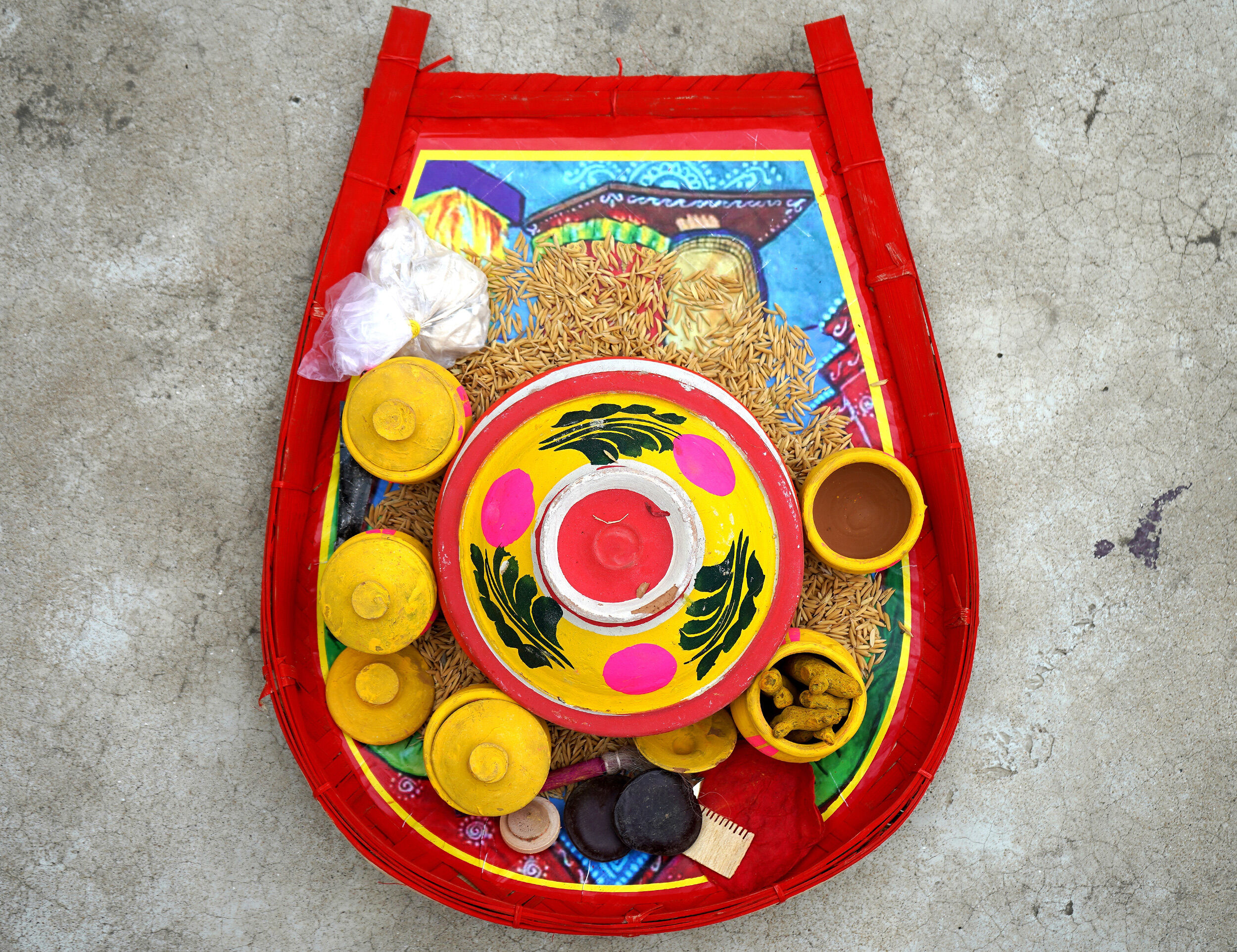 Colorful Akshaya Tritiya puja thali with grains, painted pot, and traditional offerings