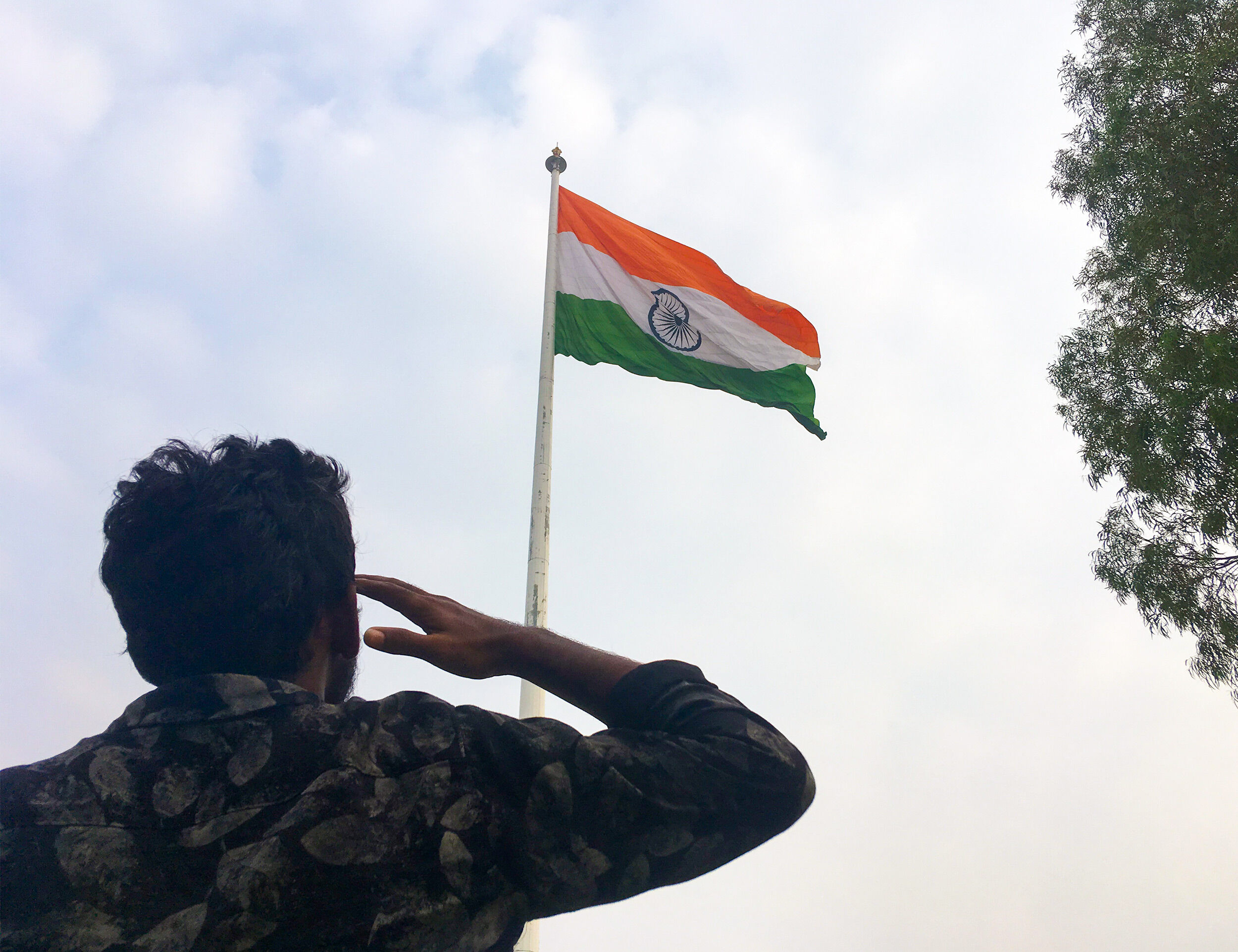 A man respectfully salutes indian national flag on republic day
