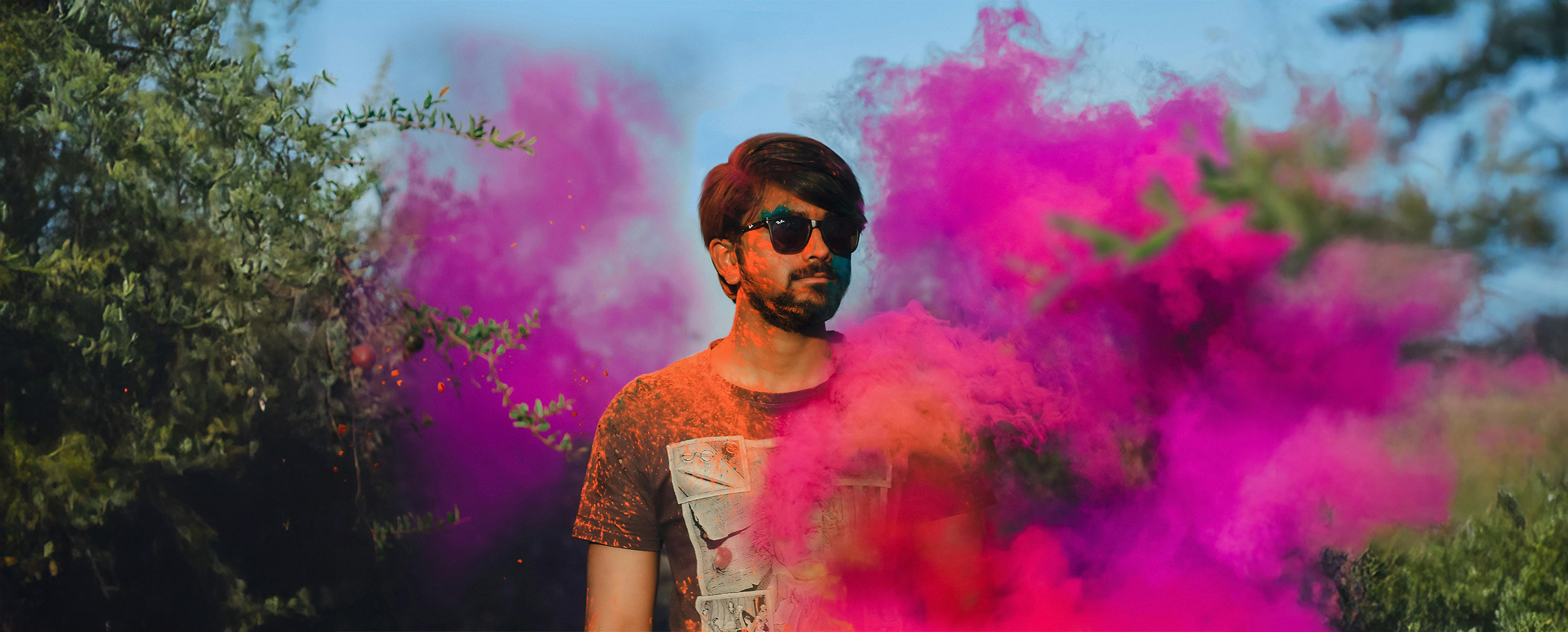 A man enjoying with colours in holi festival A man enjoying with colours in holi festival