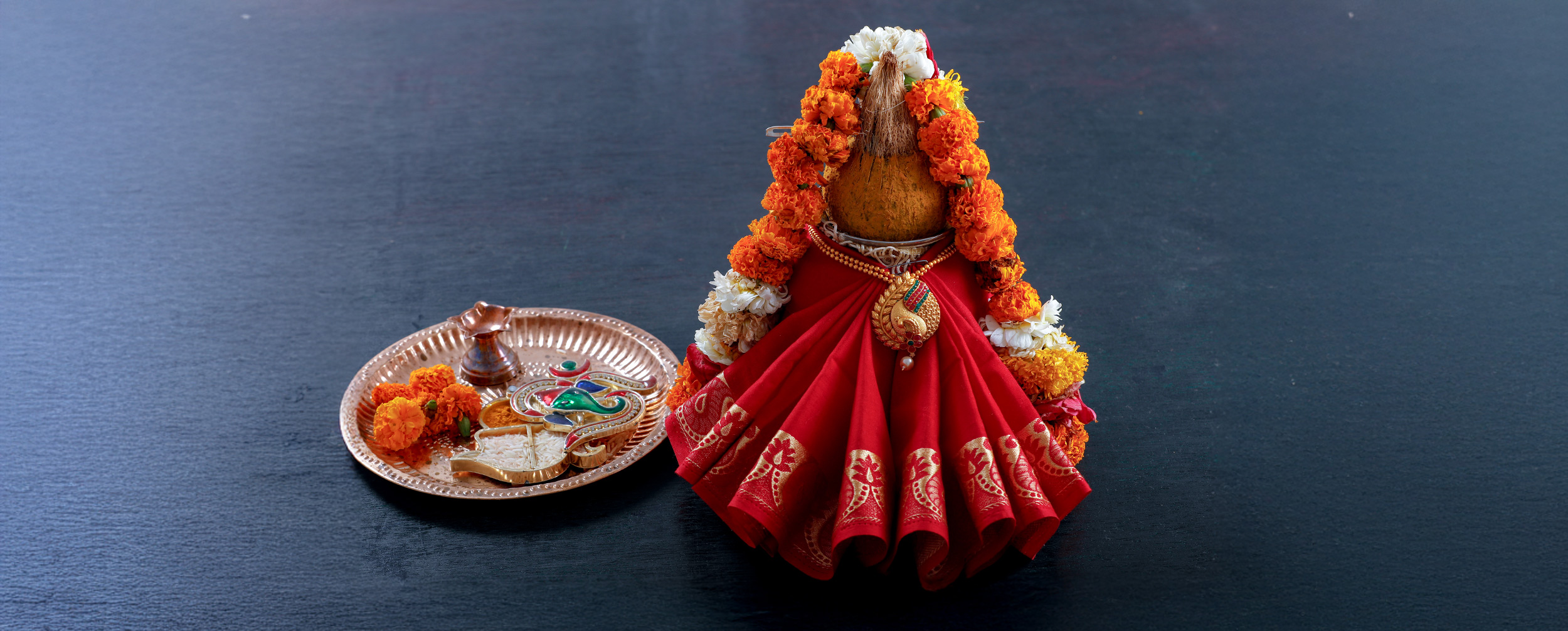 Decorated Kalash with marigold garlands and pooja thali for Akshaya Tritiya celebration Decorated Kalash with marigold garlands and pooja thali for Akshaya Tritiya celebration