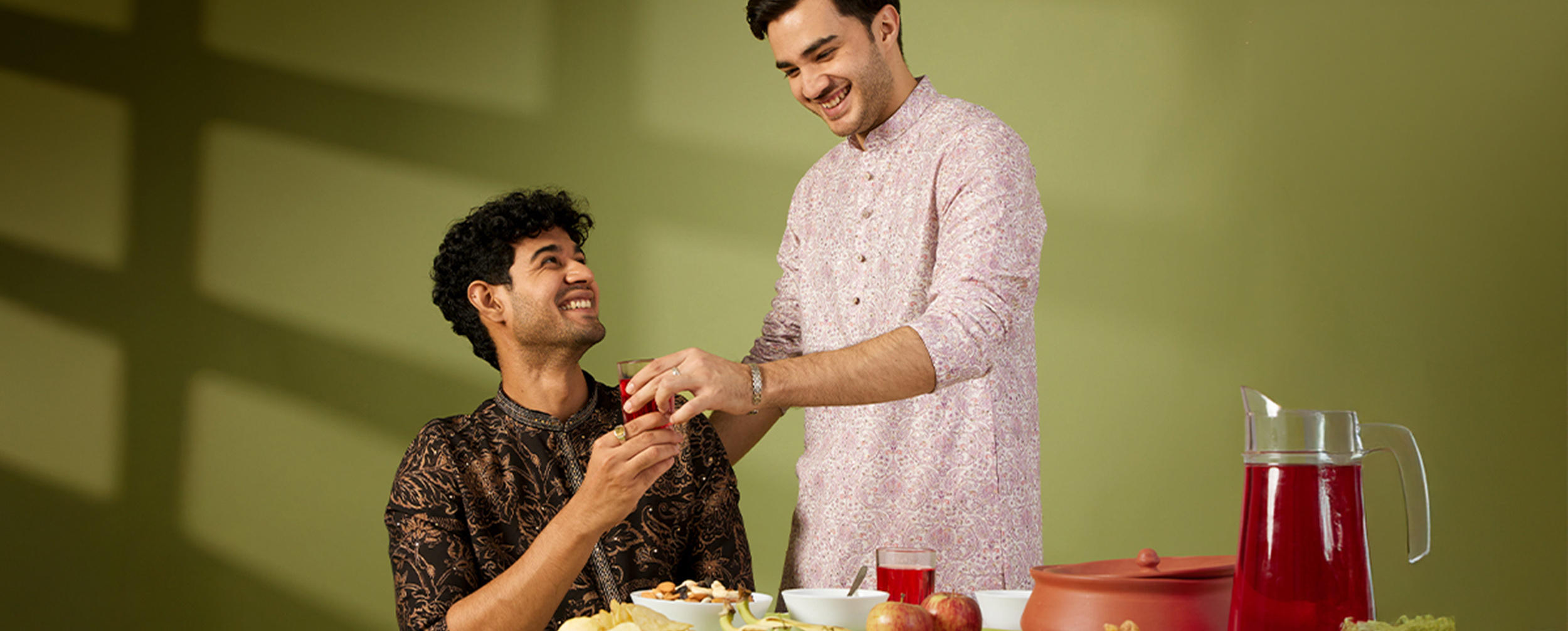 Two men wearing relaxed-fit festive kurtas demonstrate how breathable fabrics, comfortable silhouettes, and proper tailoring create a flattering look for plus-size body types.