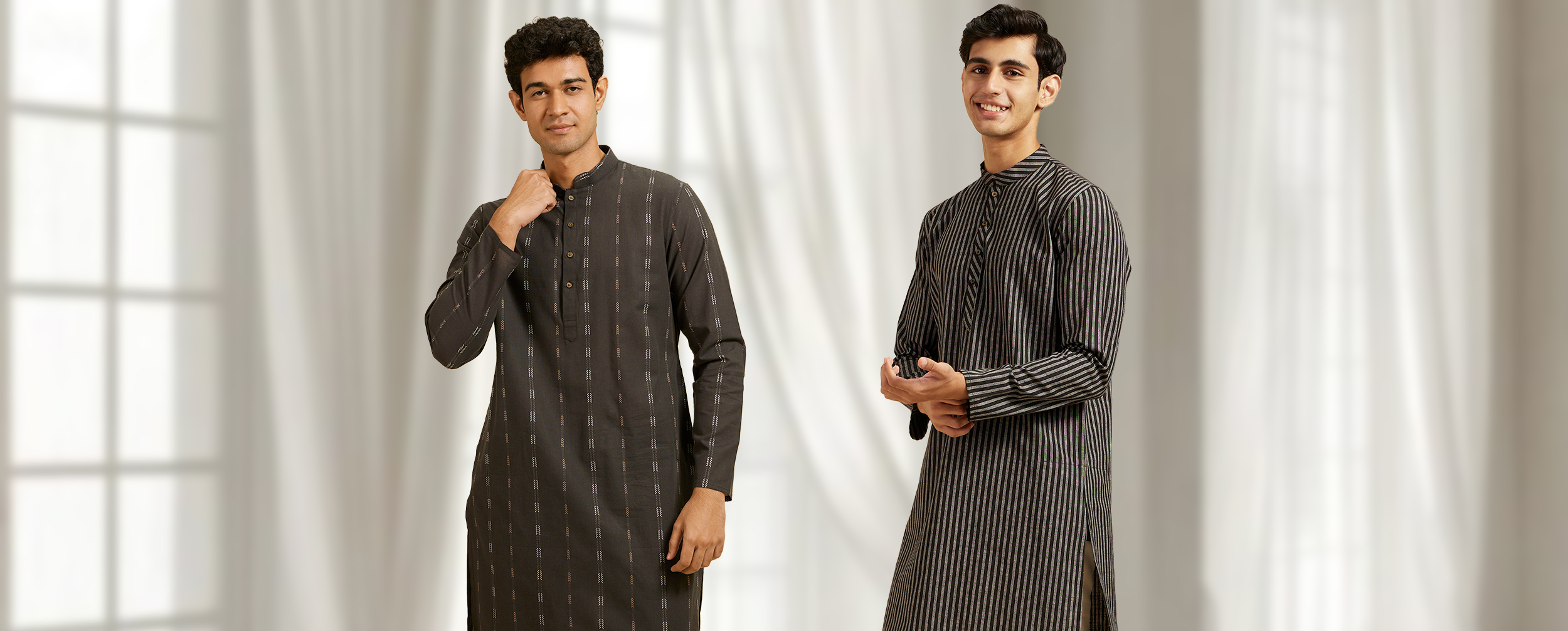 Two men wearing stylish black Chikankari kurtas — one with vertical embroidered patterns and the other with fine pinstripes — paired with contrasting trousers, showcasing versatile ethnic wear perfect for both day and night looks. Two men wearing stylish black Chikankari kurtas — one with vertical embroidered patterns and the other with fine pinstripes — paired with contrasting trousers, showcasing versatile ethnic wear perfect for both day and night looks.