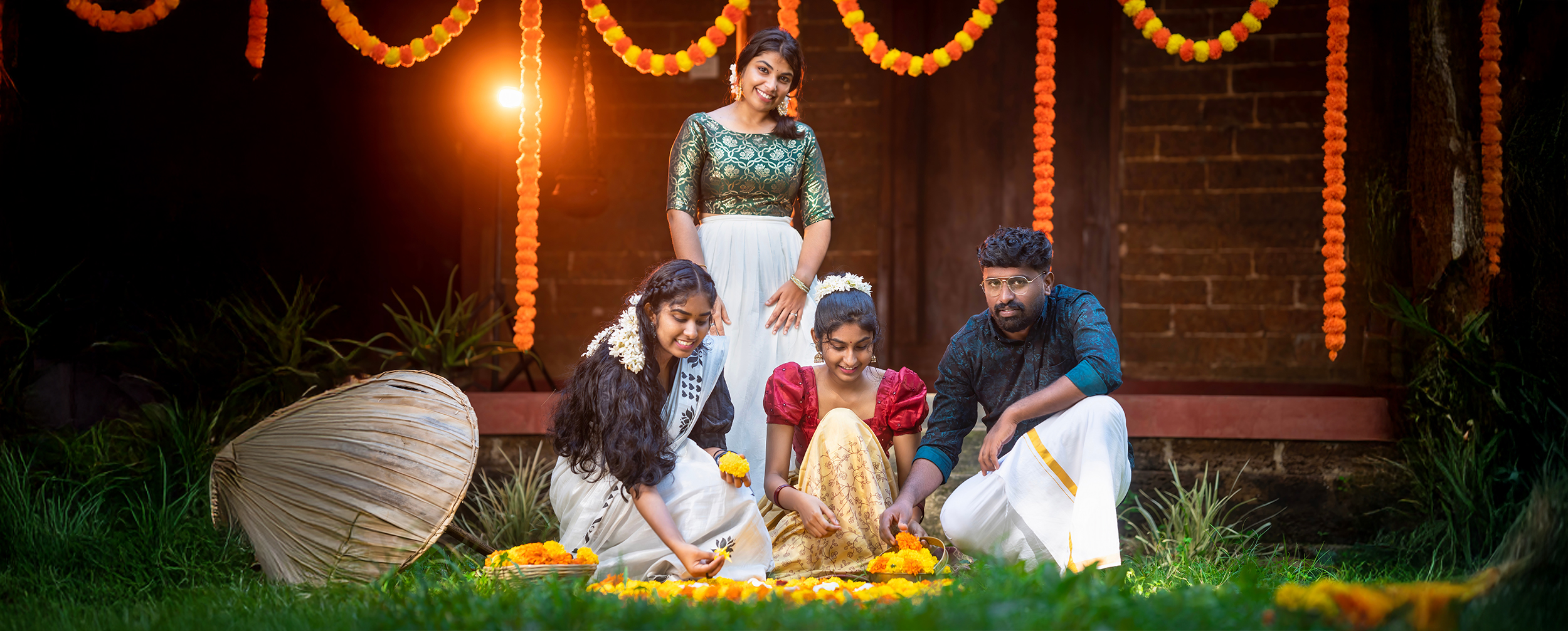 tamil family celebrating and applying flower rangoli wering traditional attire for pongal celebration tamil family celebrating and applying flower rangoli wering traditional attire for pongal celebration