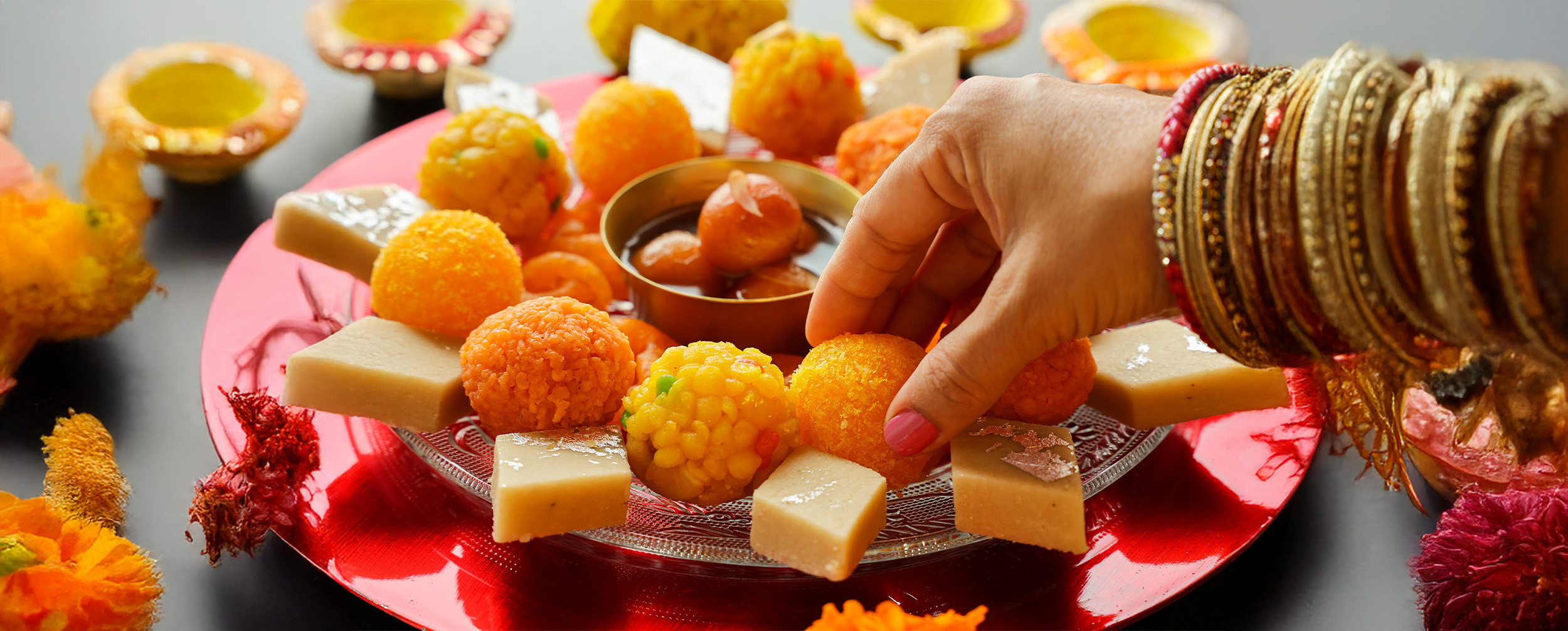 A festive silver plate filled with traditional Ram Navami sweets, including laddus, barfis, and gulab jamuns, perfect for the celebration. A festive silver plate filled with traditional Ram Navami sweets, including laddus, barfis, and gulab jamuns, perfect for the celebration.
