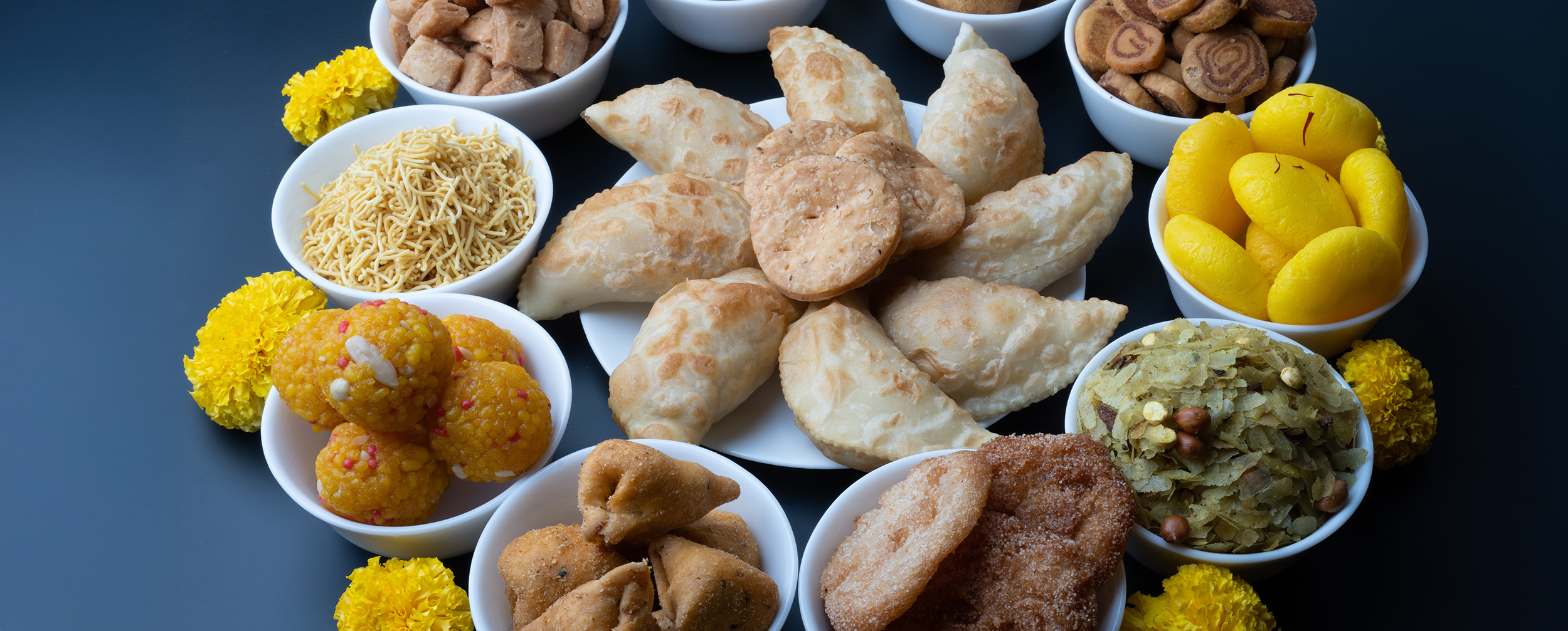 Traditional Diwali sweets and snacks like laddoo, gujiya, sev, chakli, and pedas arranged in bowls for festive celebration Traditional Diwali sweets and snacks like laddoo, gujiya, sev, chakli, and pedas arranged in bowls for festive celebration