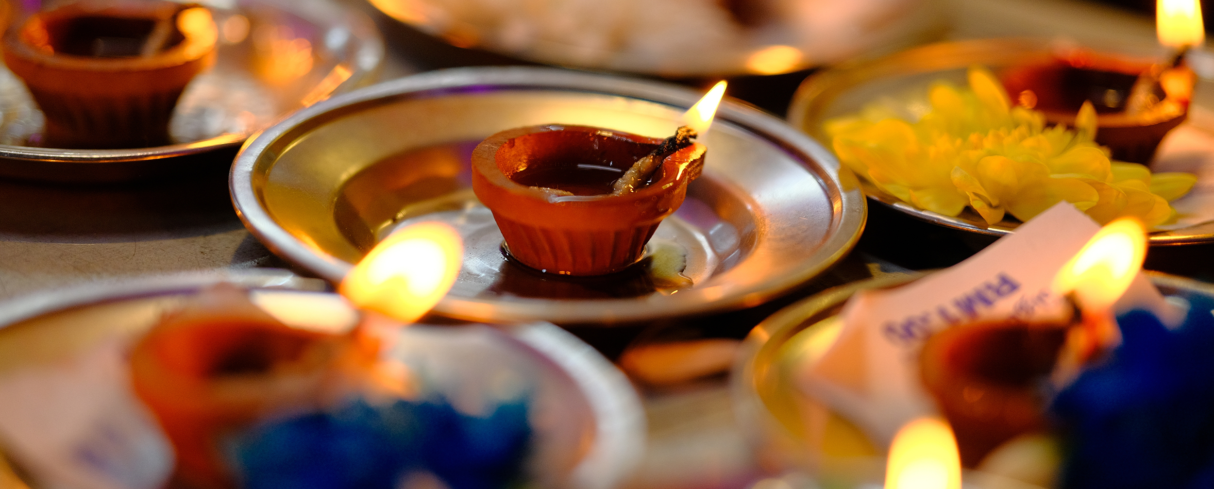 A person holding a lit earthen diya, a traditional and eco-friendly way to celebrate Diwali. A person holding a lit earthen diya, a traditional and eco-friendly way to celebrate Diwali.
