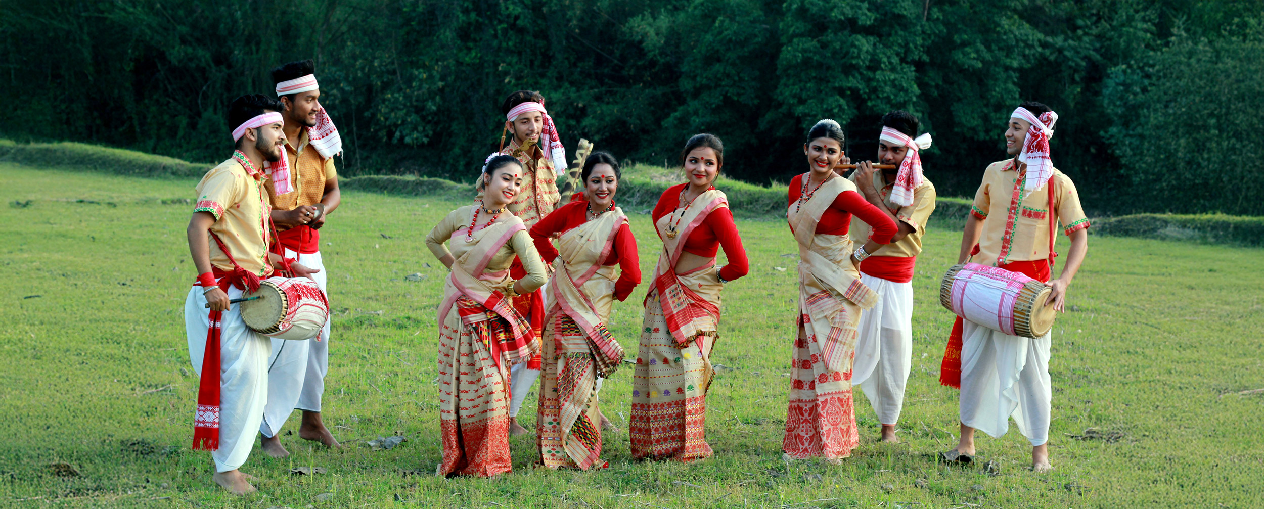 A assami group of women and men dancing in bihu style celebrating bihu A assami group of women and men dancing in bihu style celebrating bihu