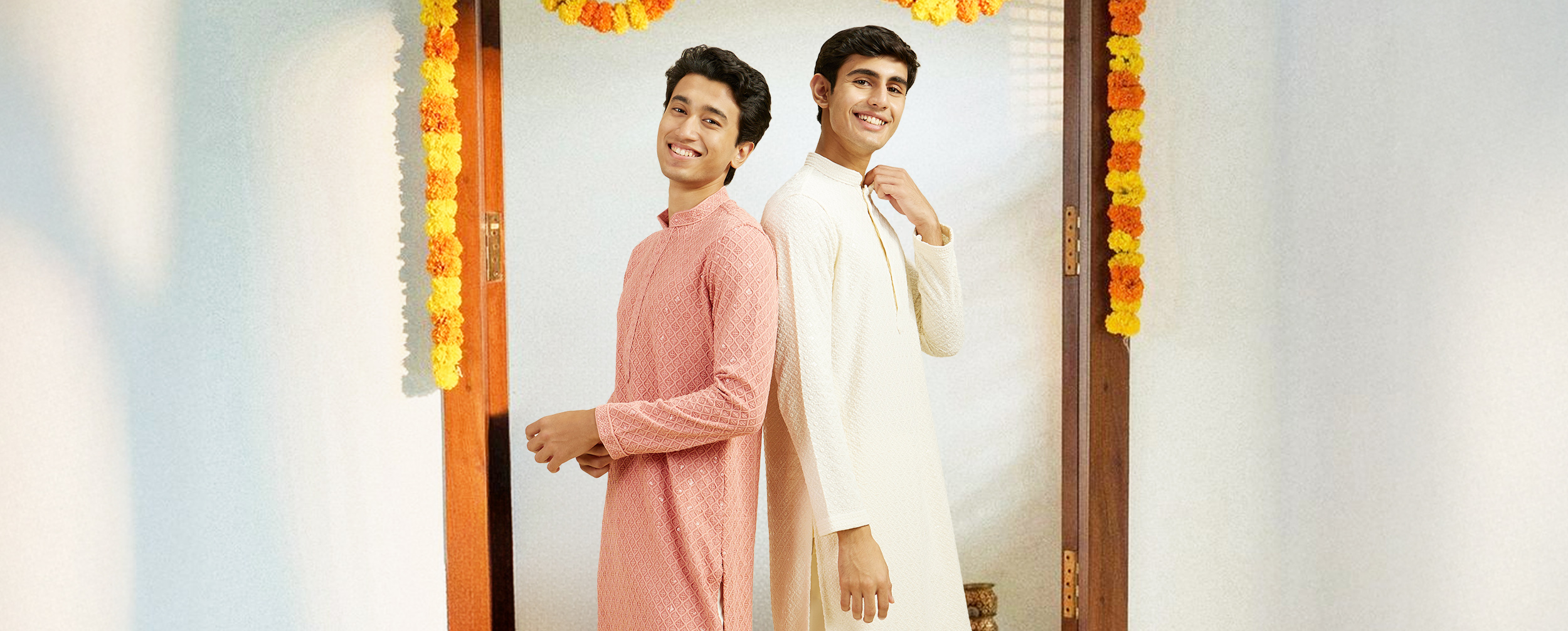 Young men in pastel kurta pajamas posing in festive traditional attire for Onam celebration Young men in pastel kurta pajamas posing in festive traditional attire for Onam celebration